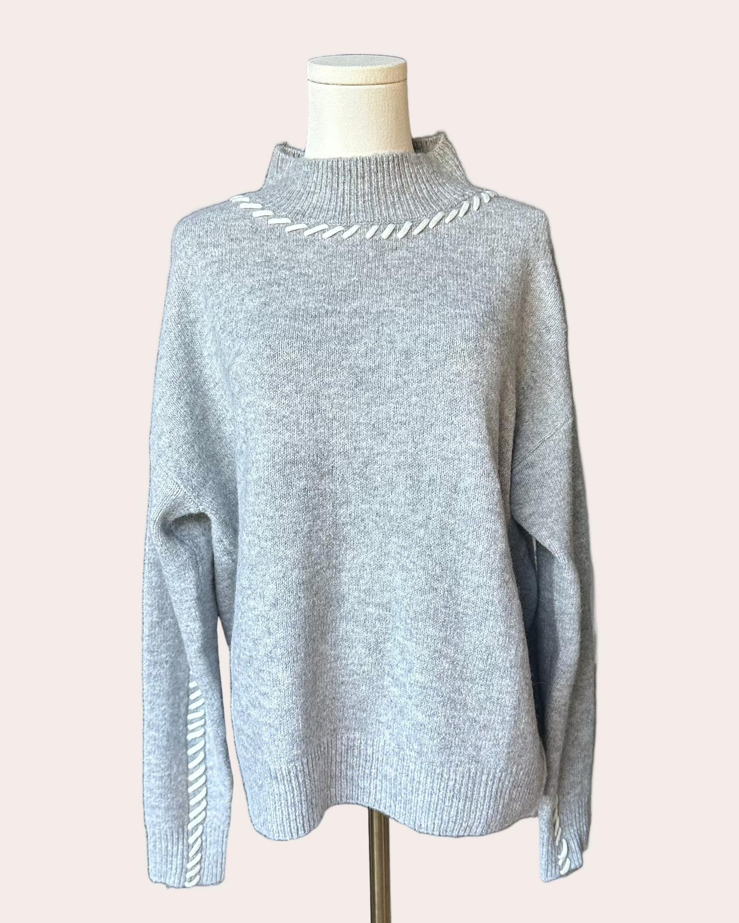 Heather grey crew-neck sweater with soft contrast stitching along the neckline and sleeves, midweight knit with stretch, photographed on a Soft Linen background for Justyna Grace Boutique.