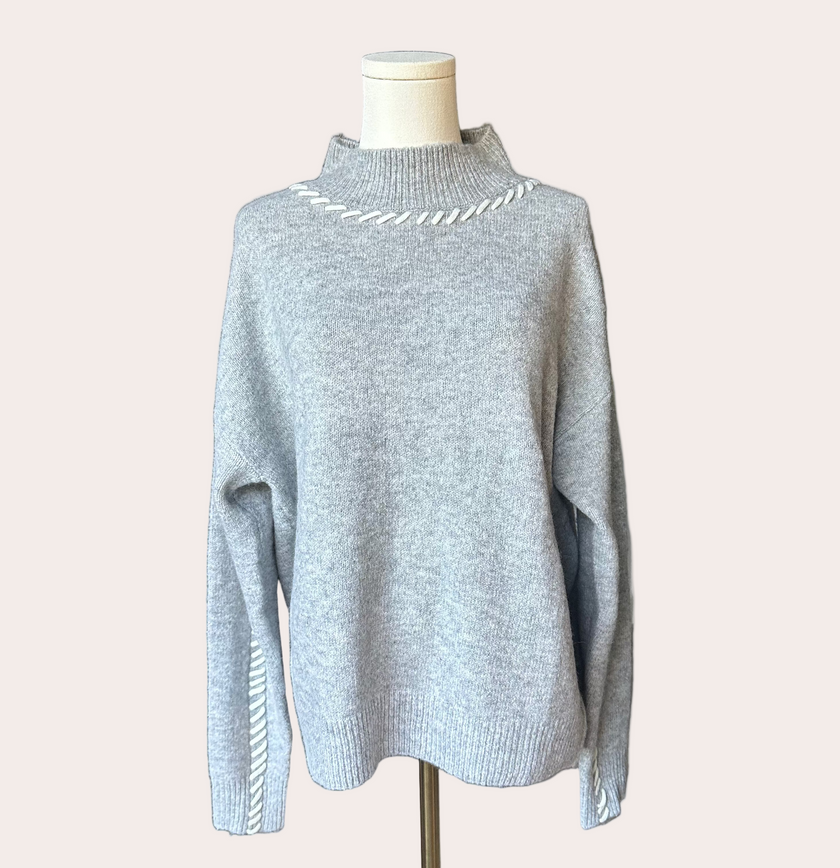Heather grey crew-neck sweater with soft contrast stitching along the neckline and sleeves, midweight knit with stretch, photographed on a Soft Linen background for Justyna Grace Boutique.
