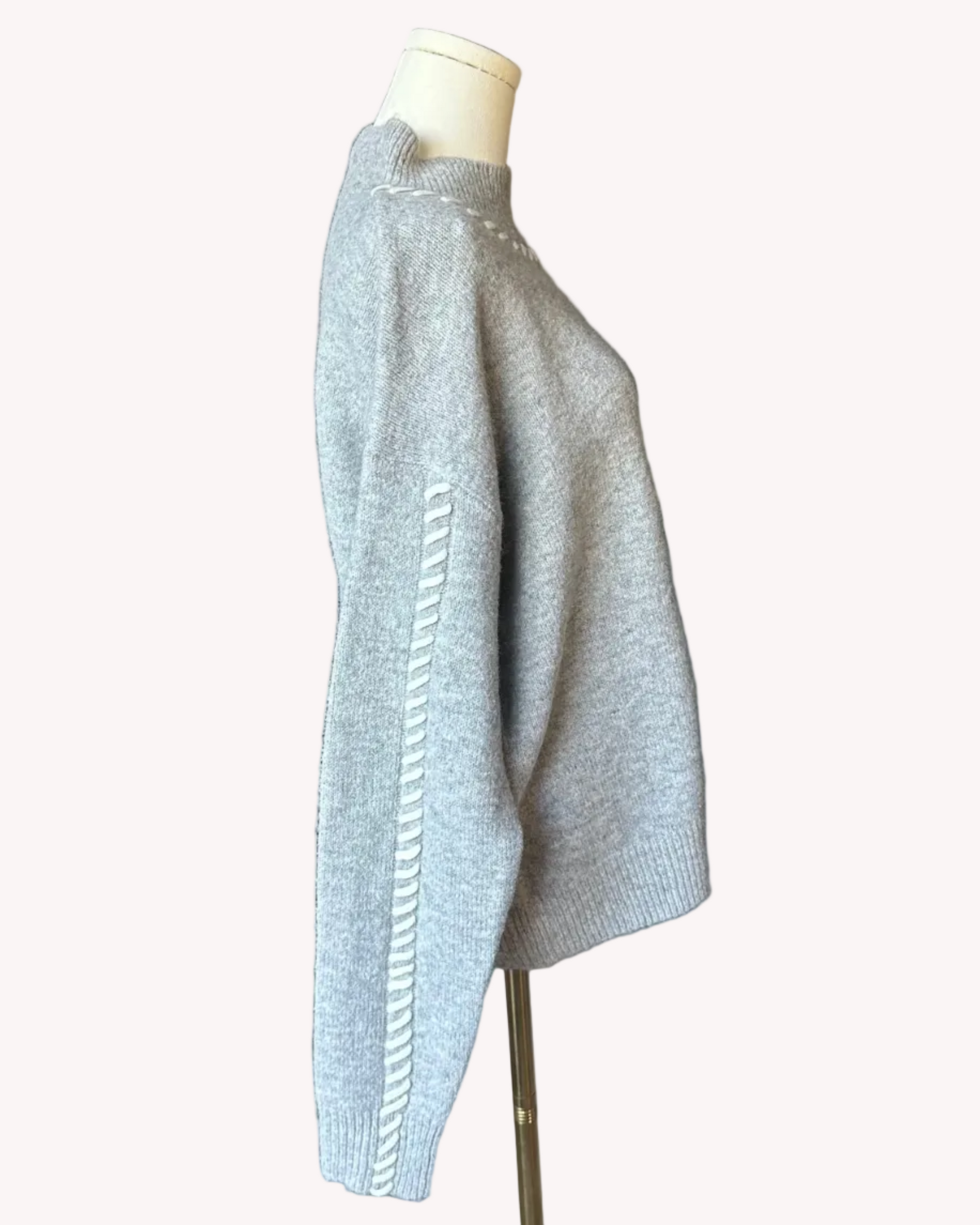 Heather grey crew-neck sweater with soft contrast stitching along the neckline and sleeves, midweight knit with stretch, photographed on a Soft Linen background for Justyna Grace Boutique.