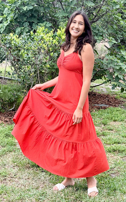 Cotton maxi dress swirling, highlighting how the tiered skirt flows and drapes