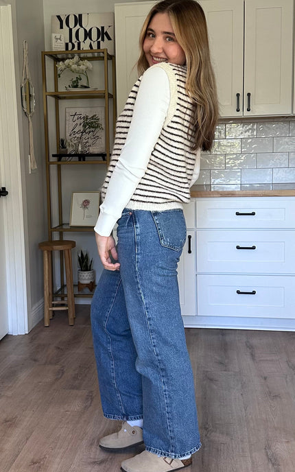 Textured button-front vest layered over a long-sleeve top
