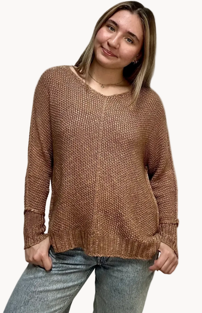 Textured knit V-neck sweater with hi-lo hem, side slits, and relaxed draped fit, shown on model 5'7 wearing size S/M in soft neutral lighting
