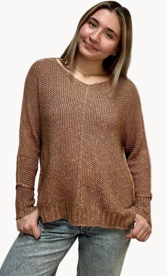Textured knit V-neck sweater with hi-lo hem, side slits, and relaxed draped fit, shown on model 5'7 wearing size S/M in soft neutral lighting
