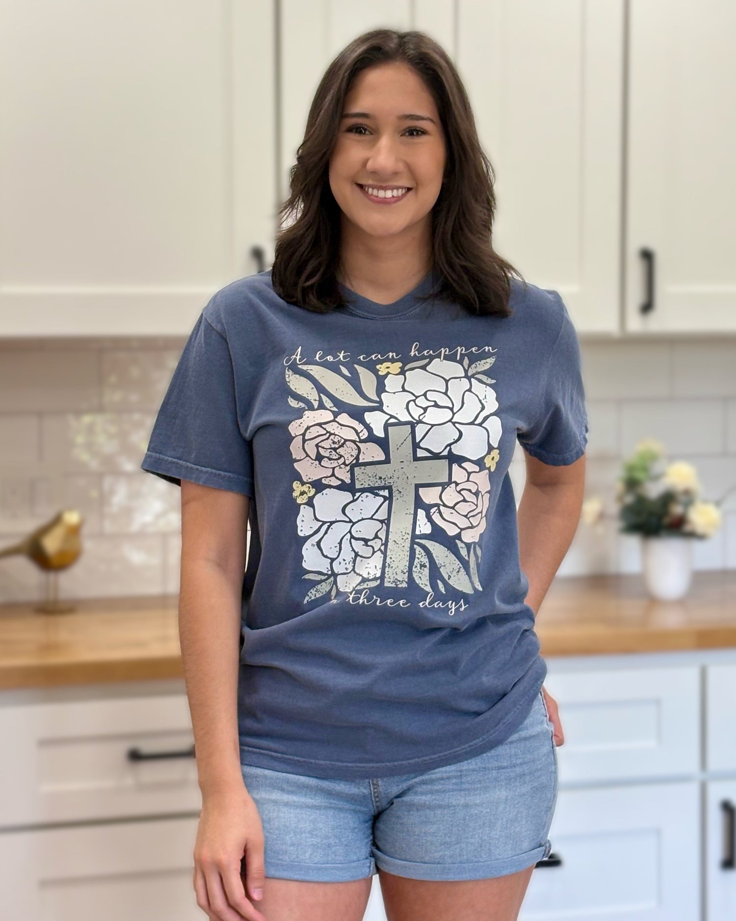 Comfort Colors “A Lot Can Happen in Three Days” Easter tee with cross and peony design, soft cotton, and relaxed unisex fit.