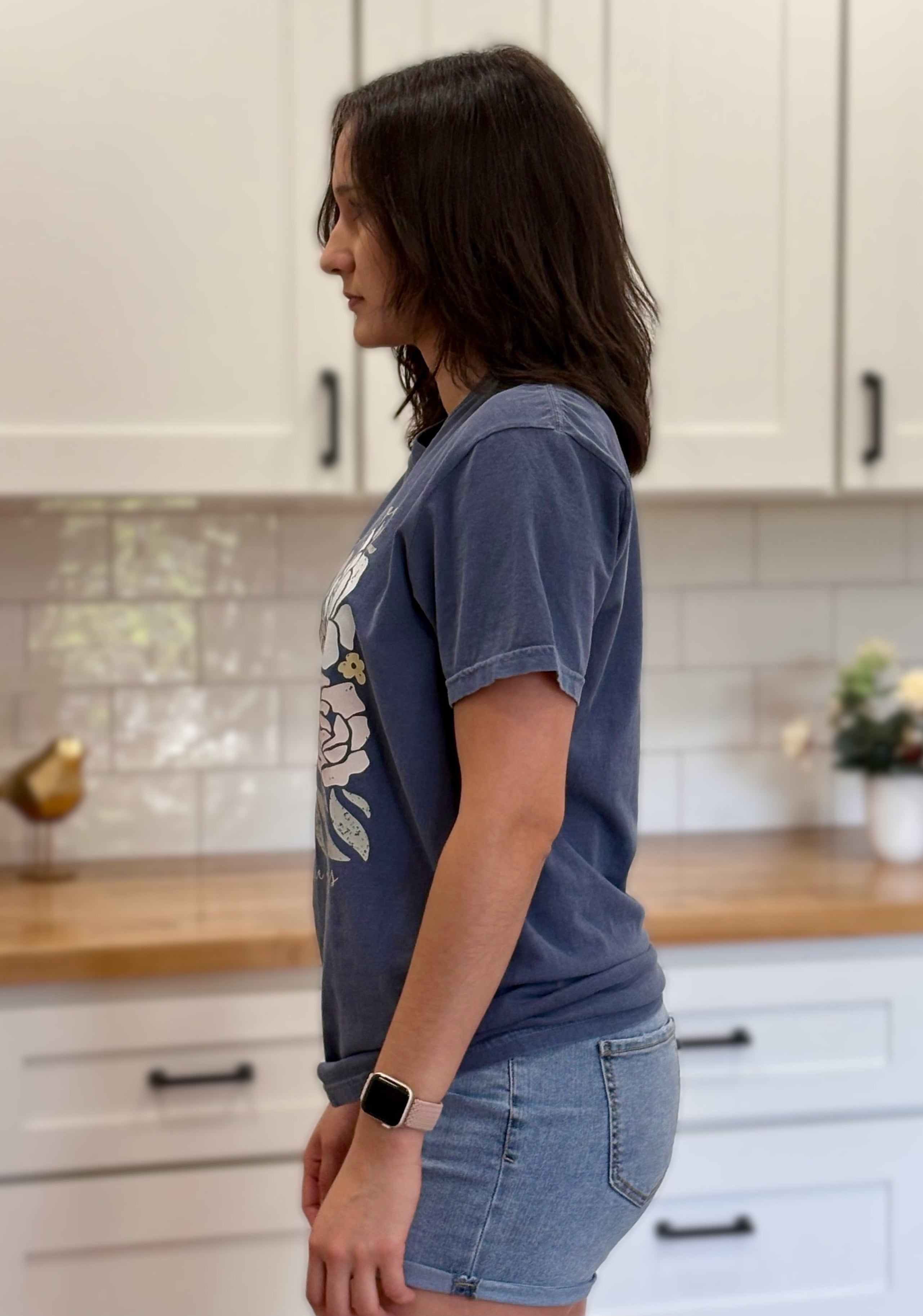 Ivory Comfort Colors “A Lot Can Happen in Three Days” Easter tee with cross and peony design, soft cotton, and relaxed unisex fit.