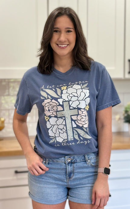 Comfort Colors “A Lot Can Happen in Three Days” Easter tee with cross and peony design, soft cotton, and relaxed unisex fit.