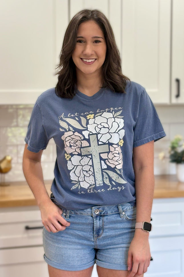 Comfort Colors “A Lot Can Happen in Three Days” Easter tee with cross and peony design, soft cotton, and relaxed unisex fit.