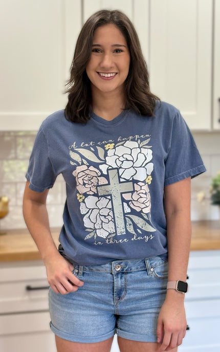 Comfort Colors “A Lot Can Happen in Three Days” Easter tee with cross and peony design, soft cotton, and relaxed unisex fit.