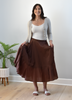 Tiered A-Line Midi Skirt — crisp structured midi with high-fitted waistband and gathered silhouette from Justyna Grace Boutique.