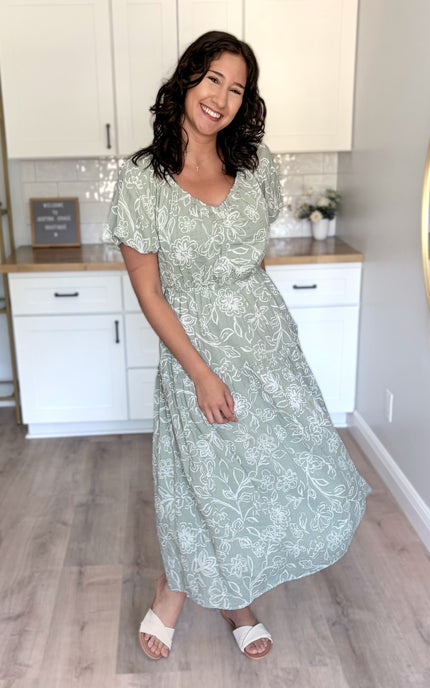 Tiered midi dress on model (5'8", Size Small, Bust 37"), showing V-neckline and soft silhouette