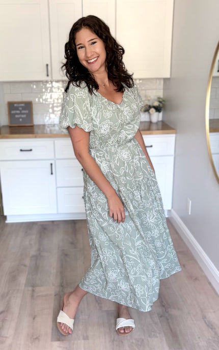 Everyday midi dress featuring flattering V-neckline, short puff sleeves, and tiered skirt detail