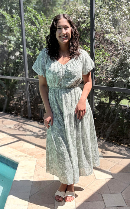Woman wearing soft tiered midi dress styled for everyday comfort and casual elegance