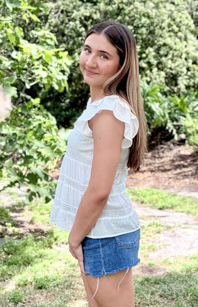 Side view of tiered ruffle top with soft drape