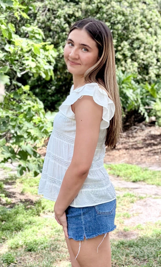 Side view of tiered ruffle top with soft drape