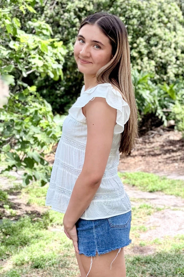 Side view of tiered ruffle top with soft drape