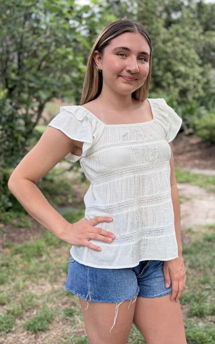 Side view of tiered ruffle top with soft drape