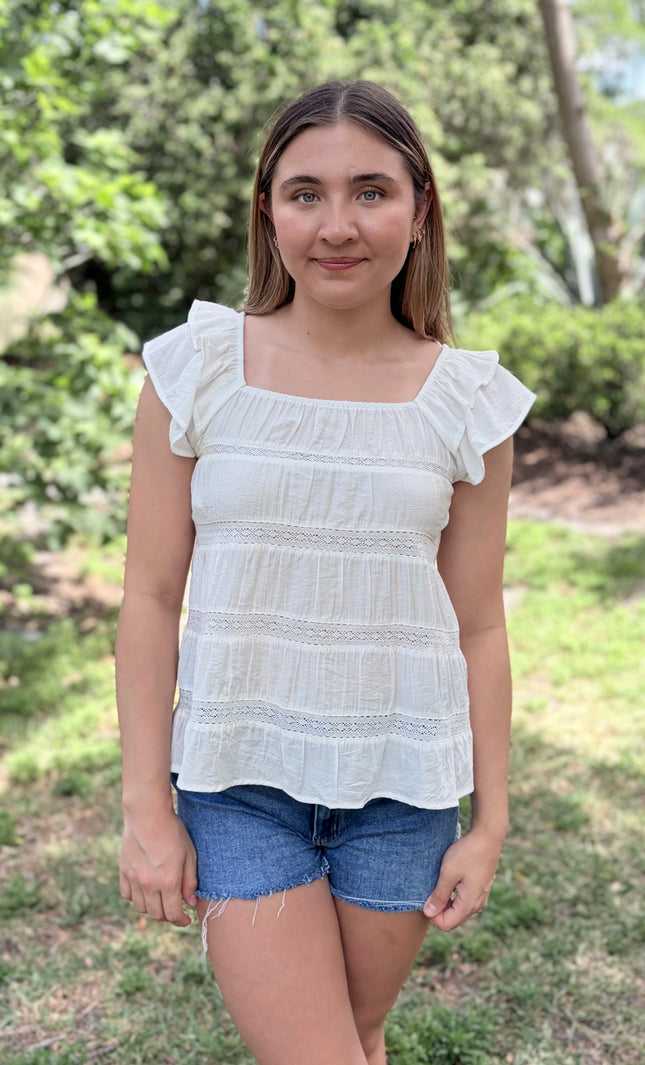 Tiered ruffle top with square neckline and flutter sleeves front view
