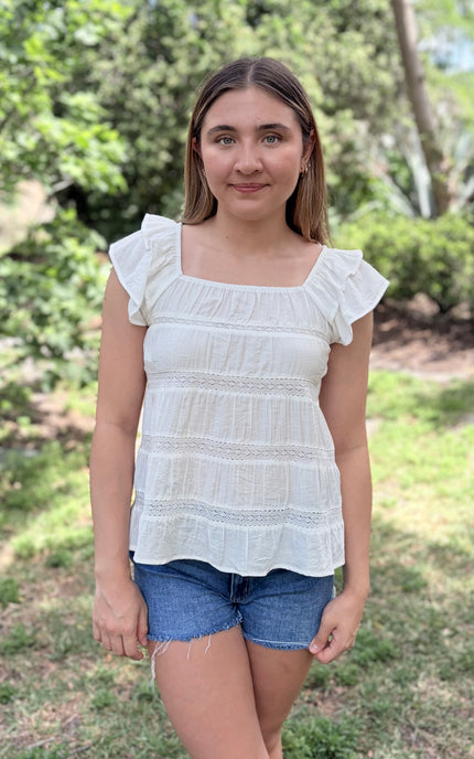 Tiered ruffle top with square neckline and flutter sleeves front view
