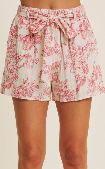 Front detail of high-rise toile-print shorts showing self-tie belt, belt loops, and flowy viscose blend fabric