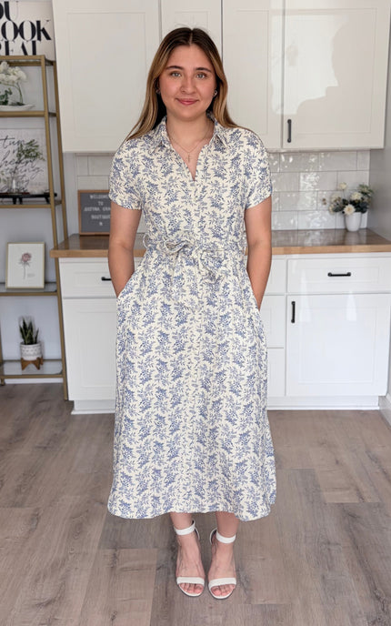 Front view with pockets of Valerie floral cotton shirt dress with rolled sleeves and self-tie waist belt. 