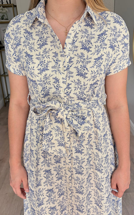 Detail view of Valerie floral cotton shirt dress with rolled sleeves and self-tie waist belt