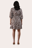 The Wild Grace Zebra Tie Dress in ivory and brown — round neckline, 3/4 sleeves, and adjustable waist tie from Justyna Grace Boutique.