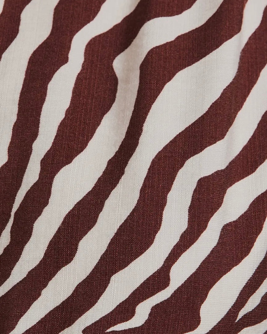 The Wild Grace Zebra Tie Dress in ivory and brown — round neckline, 3/4 sleeves, and adjustable waist tie from Justyna Grace Boutique.