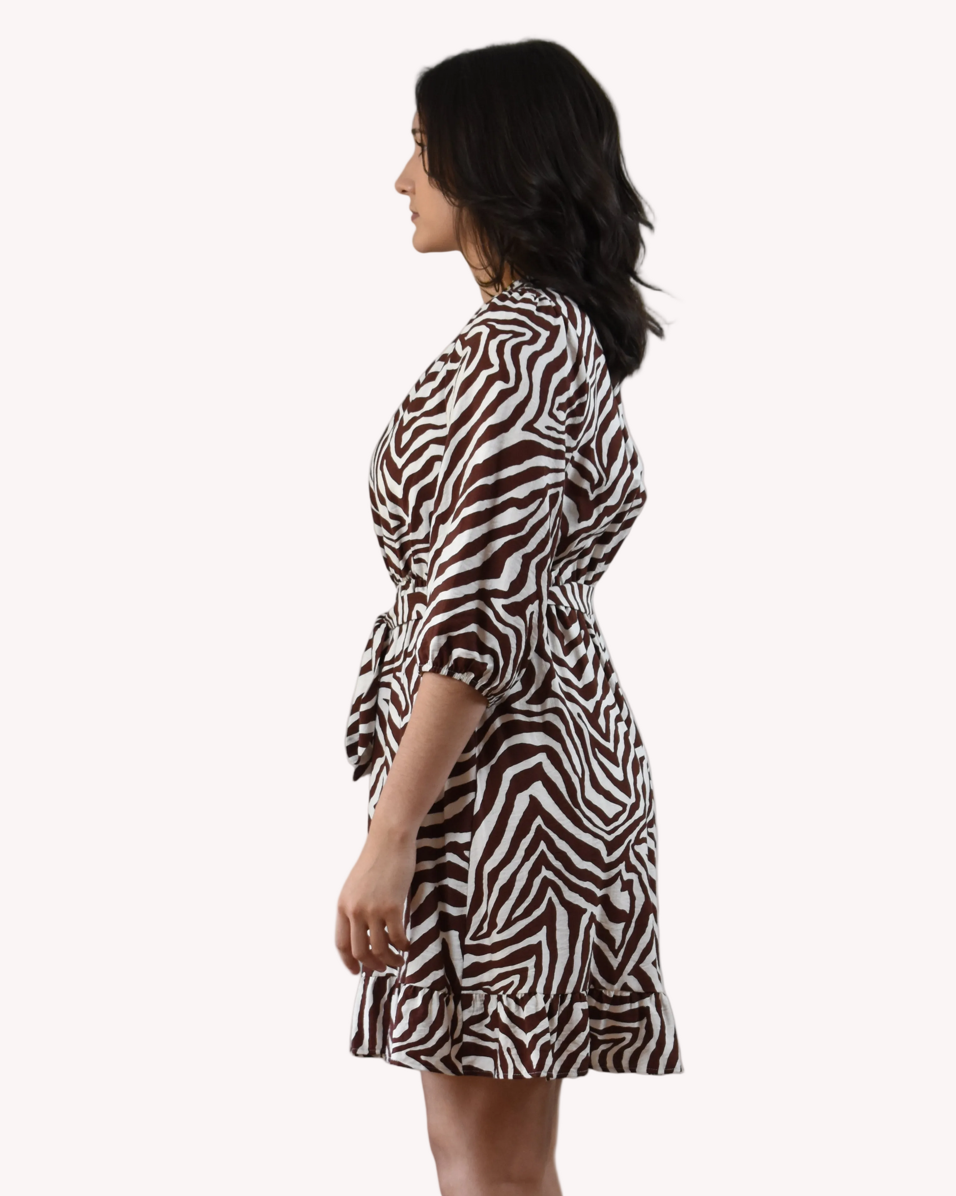 The Wild Grace Zebra Tie Dress in ivory and brown — round neckline, 3/4 sleeves, and adjustable waist tie from Justyna Grace Boutique.