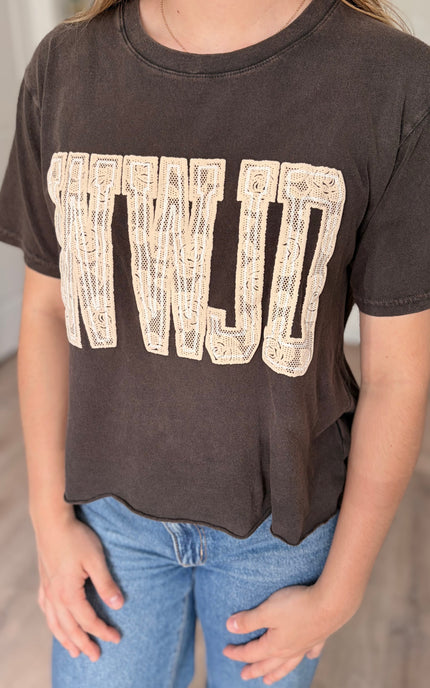 Close up of WWJD lace puff graphic cotton t-shirt with faux crop length