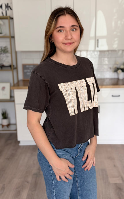 Side view of WWJD lace puff graphic cotton t-shirt with faux crop length